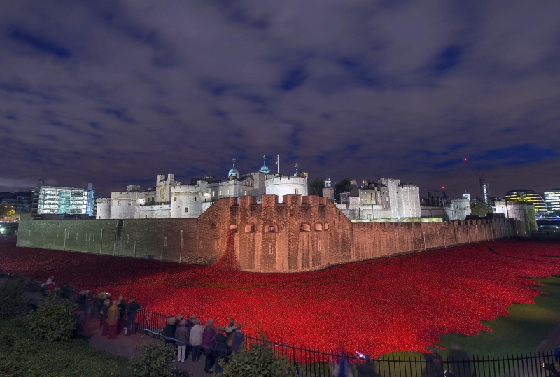 The Tower of London with the evolving art installation 'Blood Swept Lands and Seas of Red'. The major art installation named “Blood Swept Lands and Seas of Red” consists of 888,246 handmade ceramic poppies, each poppy representing a British fatality during World War I and created by ceramic artist Paul Cummins and stage designer Tom Piper. 